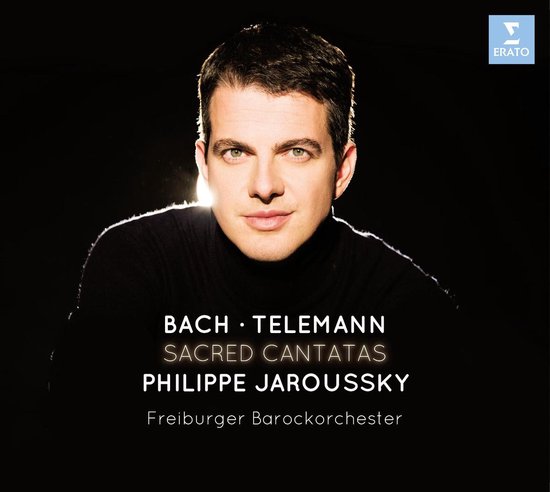 Philippe Jaroussky, countertenor, met zwarte coltrui, kijkend naar de camera. Boven: 'Bach • Telemann Sacred Cantatas Philippe Jaroussky Freiburger Barockorchester'.