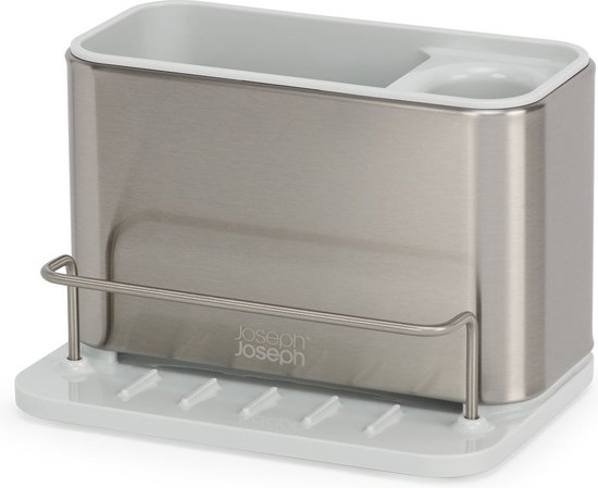 Zilverkleurige Joseph Joseph gootsteen organizer op een beige onderzetter met ribbels.