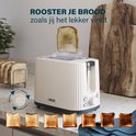 Crèmekleurige Princess broodrooster met ribbelstructuur, met verschillende gradaties geroosterd brood.