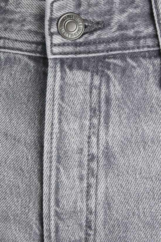 Detail van de knoop en tailleband van een grijze jeans.