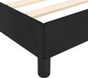 Gedetailleerde foto van de hoek van een zwart boxspringbed met een houten lattenbodem.