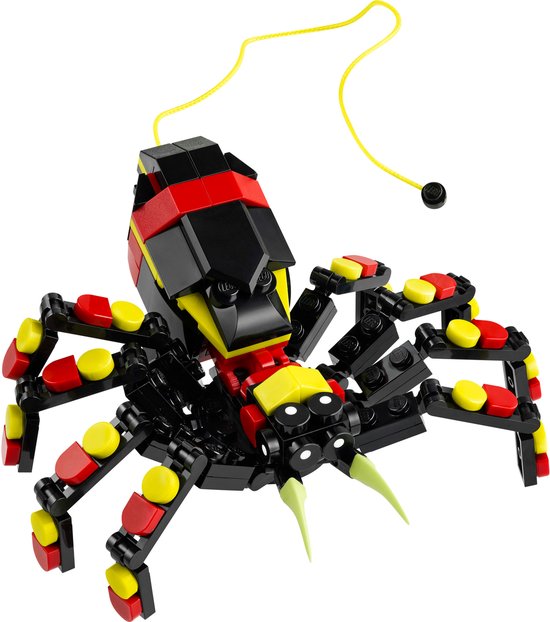 Grote LEGO spin in zwart, rood en geel met acht poten, twee tandjes en een geel koordje.