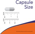 Grijze en witte capsule naast een liniaal. Toont capsulegrootte in inches en millimeters.