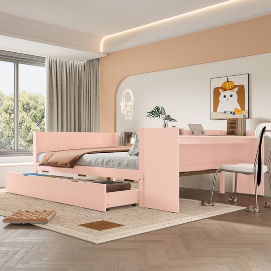 Roze slaapbank met bureau en uitgeschoven lades, in een kinderkamer.