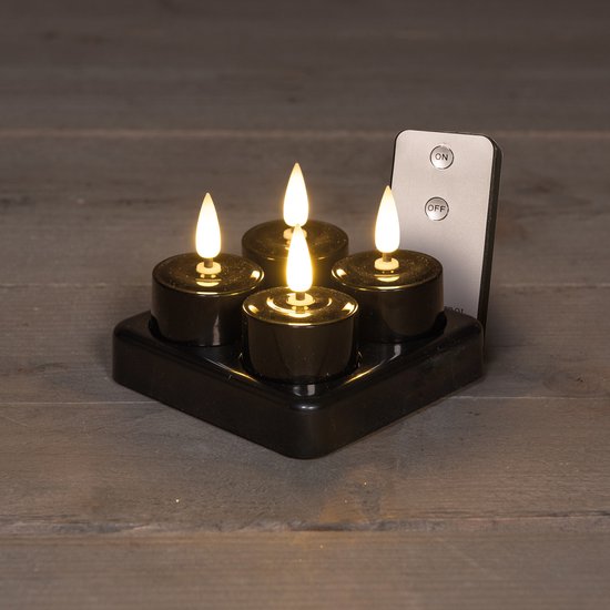 Zwarte LED theelichtjes op een zwart oplaadstation met afstandsbediening.