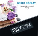 Zwarte digitale weegschaal met wellness-decoratie, groot display en 180kg max.