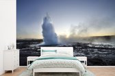 Behang - Fotobehang Een mistig beeld van de Geysir in IJsland - Breedte 420 cm x hoogte 280 cm