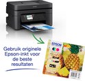 Zwarte Epson printer naast een pakje 604XL inktcartridges met ananasafbeelding; tekst: 'Gebruik originele Epson-inkt'.
