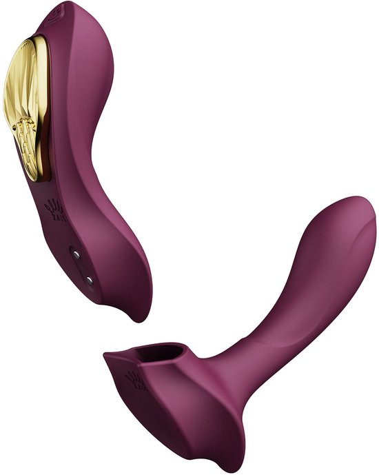 Vibrateur violet démonté, avec accent doré et deux parties, sur fond blanc.