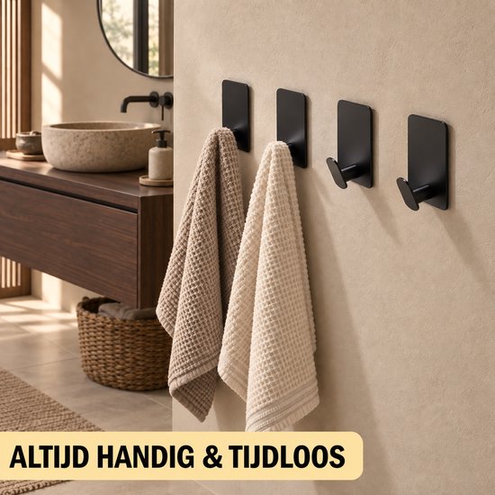 Zwarte handdoekhaken aan een muur met twee geweven handdoeken, beige en crème van kleur.
