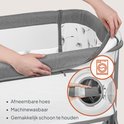 Handen tonen hoe de afneembare hoes van de grijze co-sleeper verwijderd wordt voor wassen.