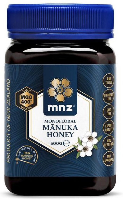 Donkerbruine pot Manuka Honing 500g met blauw deksel. Goud en wit label met bloem en tekst.