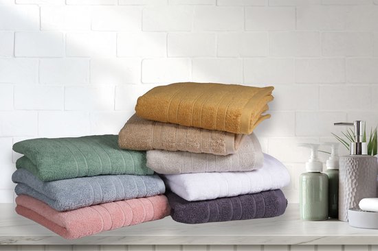 Deux piles de serviettes de différentes couleurs : vert, bleu clair, vieux rose, moutarde, beige, gris, blanc et violet foncé.