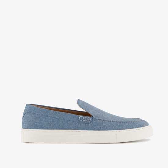 Blauwe denim instapper met witte zool, gezien vanaf de zijkant.
