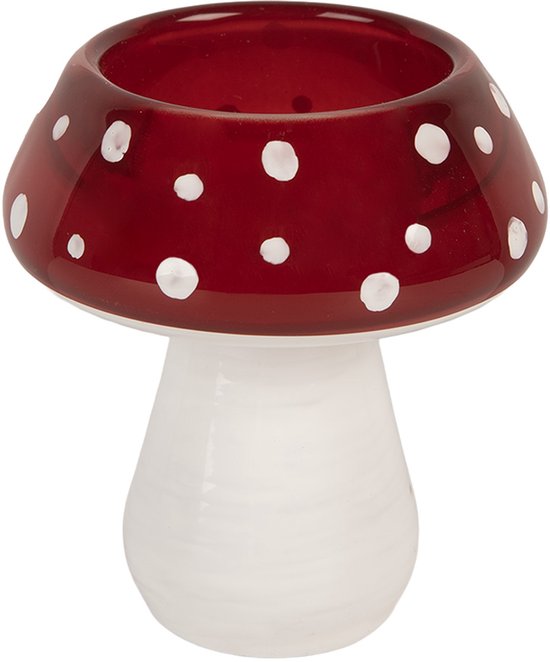 Bougeoir en verre rouge à pois blancs en forme de champignon.