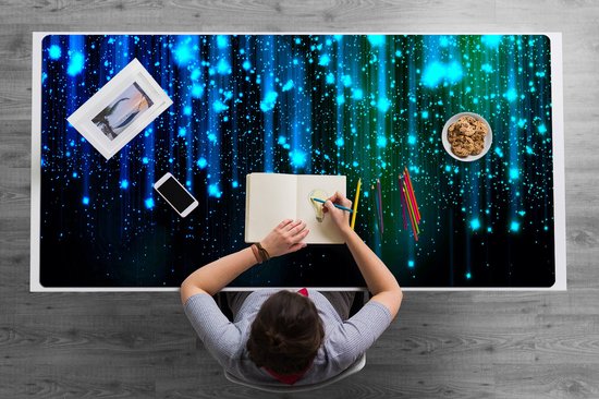 Sous-main avec des effets de lumière et de poussière d'étoiles bleues et vertes.