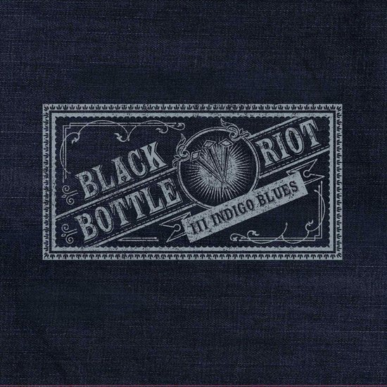 Close-up van een albumhoes met denim textuur en een label met "BLACK BOTTLE RIOT III INDIGO BLUES".