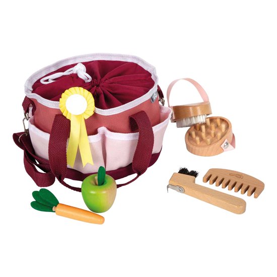 Paardenverzorgingsset met tas, borstels, kam, appel, wortel en rozet.