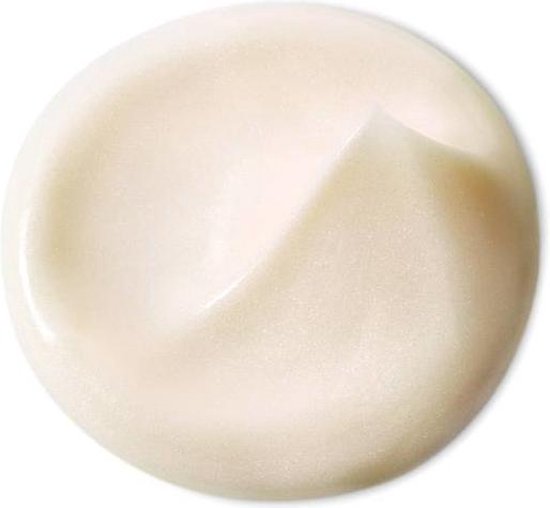 Een cirkelvormige, romige, lichtgele crème met een swirls textuur.