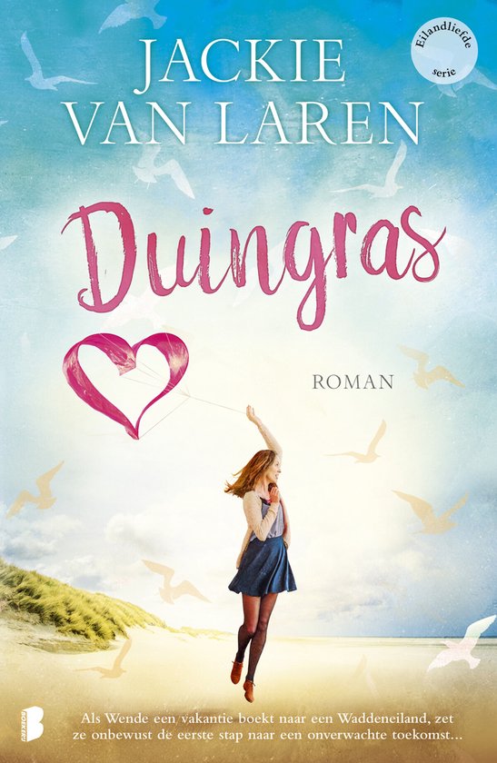 Boek 'Duingras' van Jackie van Laren. Een vrouw met rood haar laat een hartvormige vlieger op op een strand bij de duinen.