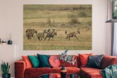 Canvas schilderij 150x100 cm - Wanddecoratie Hyena's - Jagen - Afrika - Muurdecoratie woonkamer - Slaapkamer decoratie - Kamer accessoires - Schilderijen