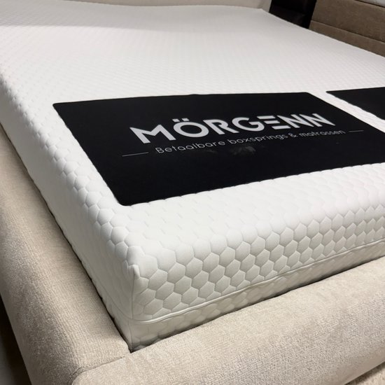 Witte matras met een zwart logo 'MÖRGENN' met de tekst 'Betaalbare boxsprings & matrassen'.