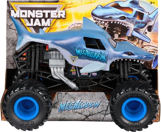Blauwe Megalodon monstertruck in verpakking. De truck heeft een haaiendesign, grote banden en de tekst 'Megalodon'.