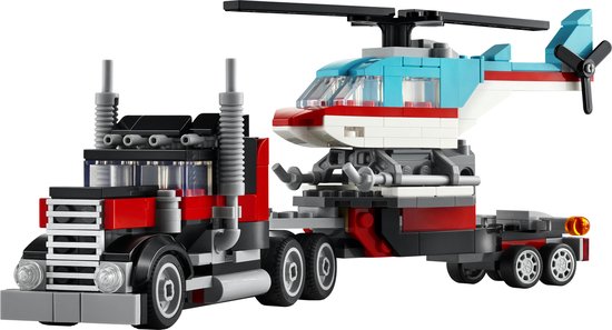 Een rode en zwarte truck met grijs chassis, getrokken door een rode en witte helikopter met blauwe details.