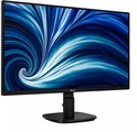 Philips monitor met dunne rand, zwart ontwerp en abstract blauw spiraalvormig schermbeeld.