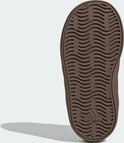 Onderkant van een bruine Adidas sneaker met golvend profiel.