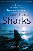 Boekomslag van "The Secret History of Sharks" met een vin van een haai die boven het water uitsteekt bij zonsondergang.