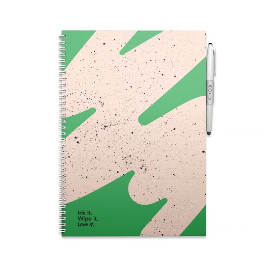 Lichtroze MOYU notitieboek met groene abstracte print, met zwarte spetters. Witte pen ernaast. Tekst op carnet: Ink it. Wipe it. Love it.