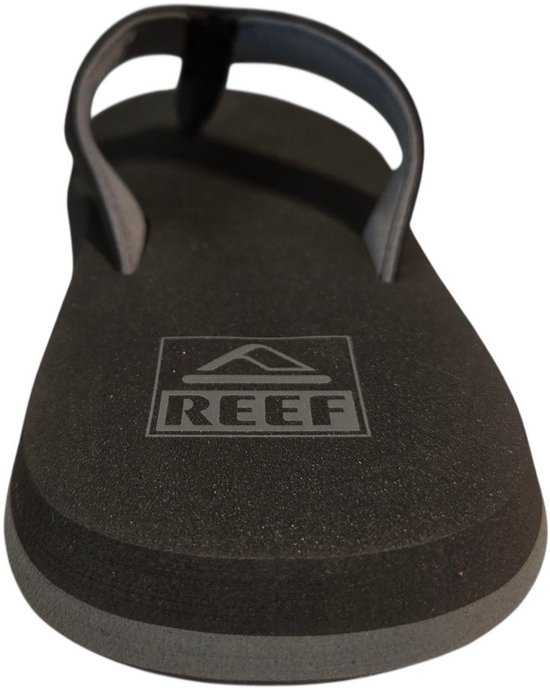 Donkergrijze Reef teenslipper, close-up van de voorkant. Het Reef logo is in de zool gedrukt.