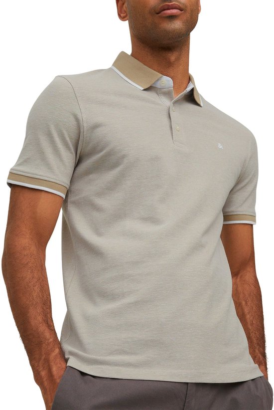 Man draagt een lichtgrijs poloshirt met beige kraag en manchetten met witte bies.