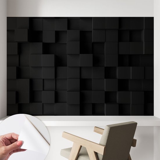 Zwarte driedimensionale kubussen fotobehang wordt aangebracht op een muur boven een houten stoel.
