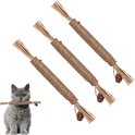 Grijze kat houdt zilverstruikspeeltje van sisal touw in bek. Drie speeltjes liggen diagonaal op witte achtergrond.