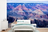 Behang - Fotobehang De gekleurde rotsen omringen de Colorado rivier in Arizona - Breedte 420 cm x hoogte 280 cm