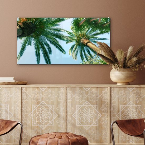 MuchoWow® Glasschilderij 80x40 cm - Schilderij acrylglas - Palmbladeren - Lucht - Zomer - Tropisch - Foto op glas - Schilderijen