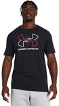 Man met dreadlocks draagt een zwart sportshirt met een grote rood-witte UA-logo opdruk. Grijze sportbroek.