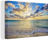 Canvas Schilderij Een zonsondergang op het strand van Aruba - 90x60 cm - Wanddecoratie