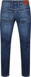 Achterkant van een man in een donkerblauwe jeans met een bruin MAC JEANS label.