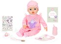 Baby pop in roze pyjama met schaap, muts, speen, flesje, slabbertje en boekje.