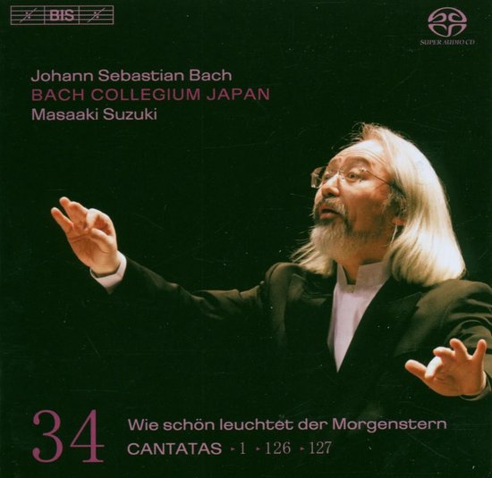 Masaaki Suzuki, dirigent van het Bach Collegium Japan, met lange witte haren en bril.