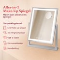 Zilverkleurige make-up spiegel met verlichting en 10x vergrotingsspiegel, inclusief accessoires.