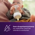 Baby drinkt uit Avent fles met anti-druppel spenenontwerp, voorkomt melkverlies.