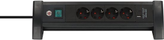 Zwarte Brennenstuhl stekkerdoos met vier stopcontacten, aan-uitschakelaar en USB-C en USB-A poorten voor op het bureau.
