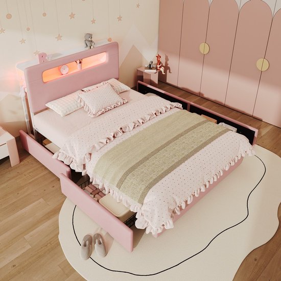 Roze bed met opbergladen, hoofdeinde met led-plank, bovenaanzicht in slaapkamer.