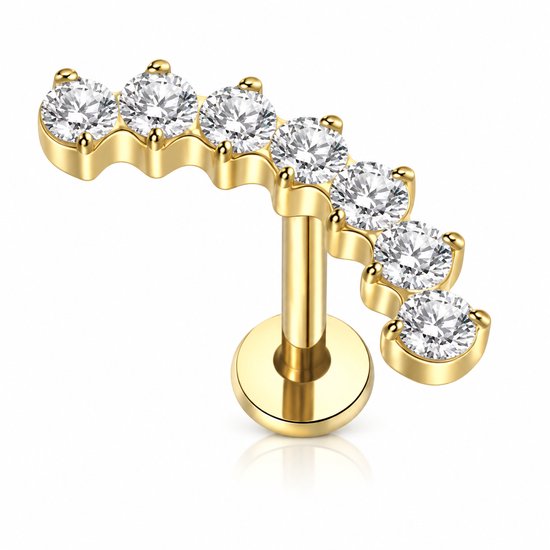 Gouden labret piercing met een gebogen rij van zes heldere stenen.