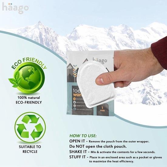 Hand pakt een enkele Häago teenthermowarmers uit een verpakking. Links een groen eco-vriendelijk label.
