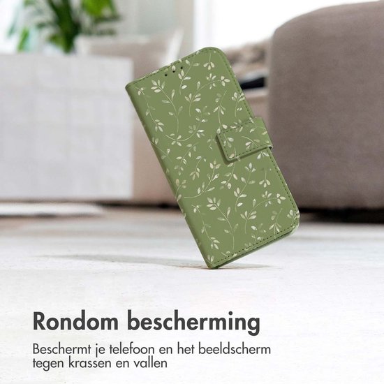 Groen telefoonhoesje met bladerpatroon op een vloer, leunend.